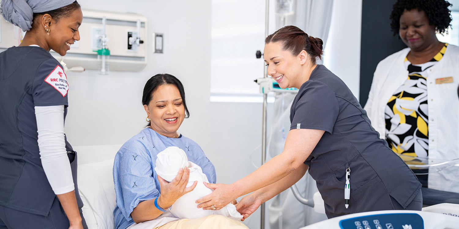 Nursing students in a hospital setting talking to a patient with a child