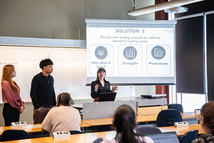 Instructor talking to a group of students in a classroom