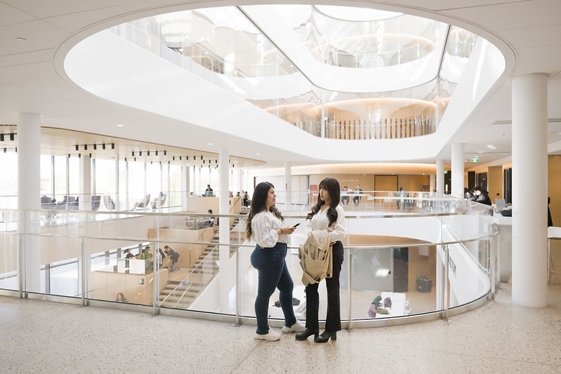 two students having a conversation in the Manitou a bi Bii daziigae building