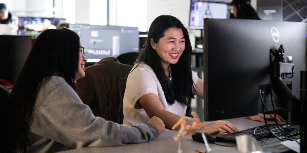 Two students looking at a computer screen