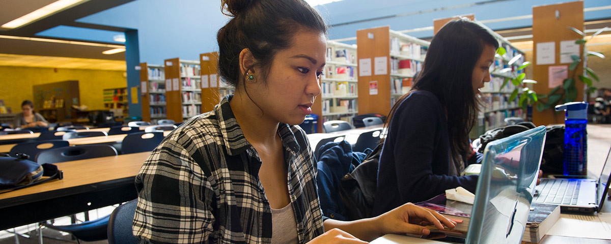 Student on a laptop in a library