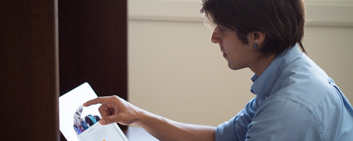 Student working on a computer in a dorm