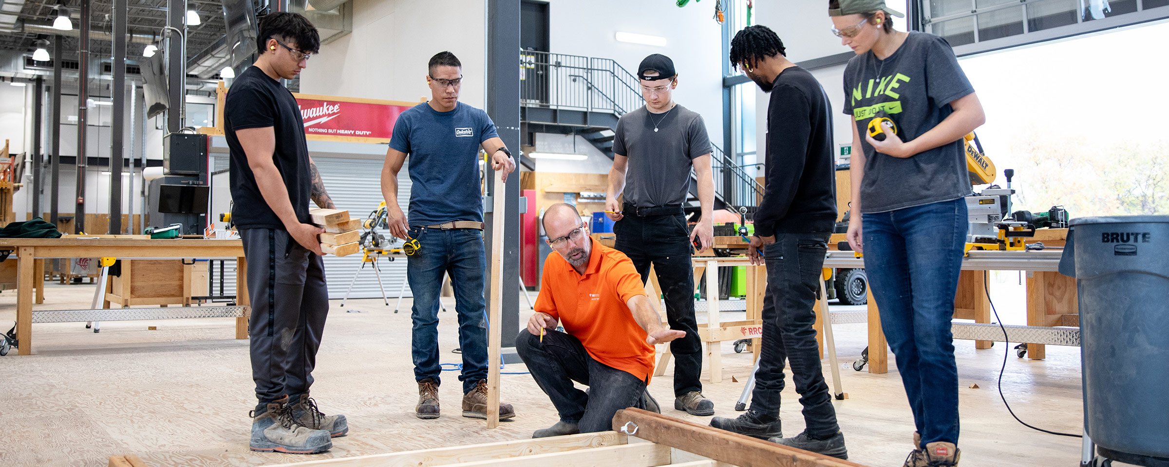 Instructor showing carpentry students a technique