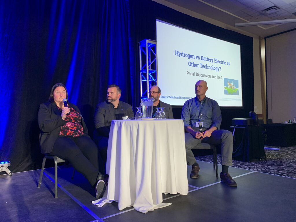 on stage panel discussion at 2023 conference