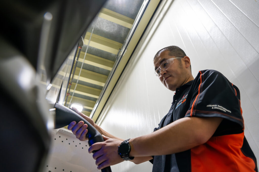 vehicle researcher plugs in electric bus