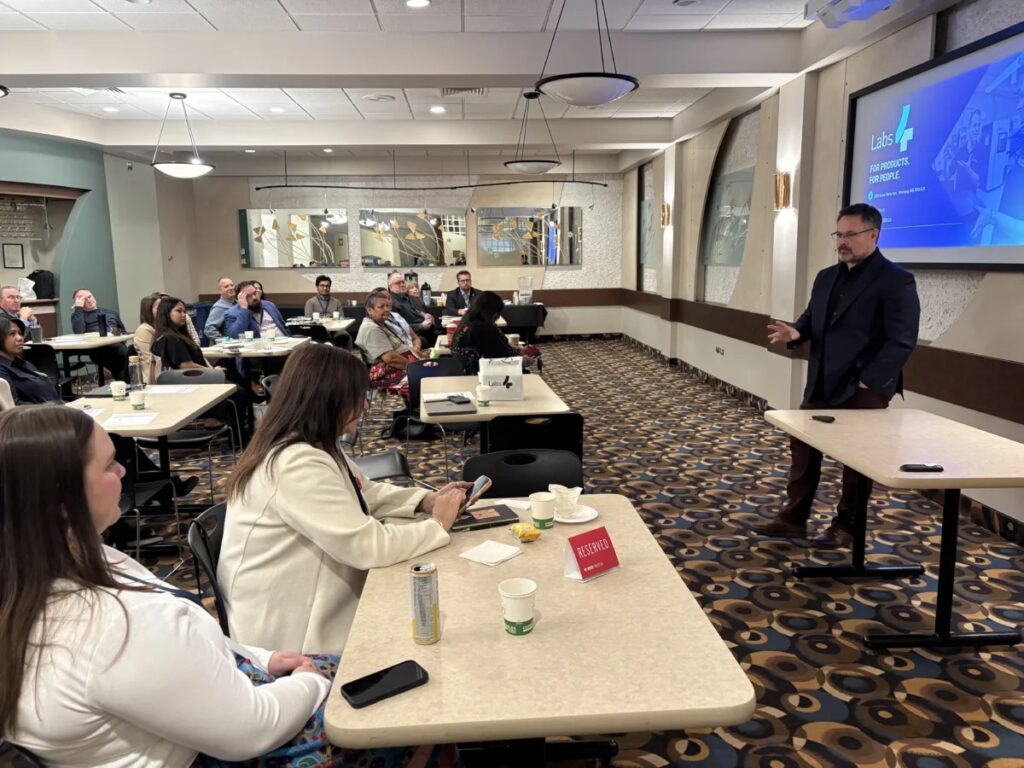 Joel Semeniuk presenting keynote to a full conference room
