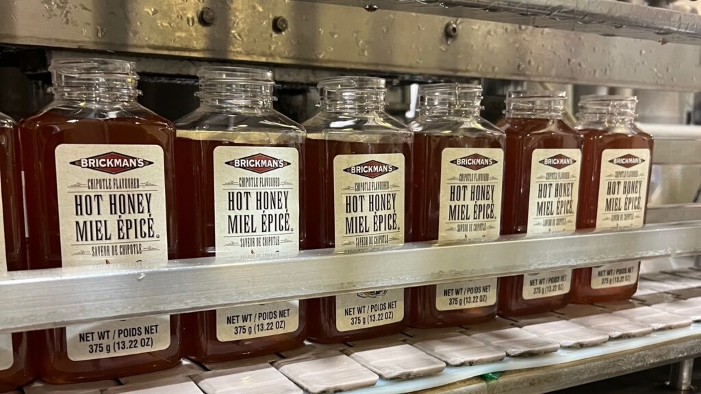 branded honey jars on the production line