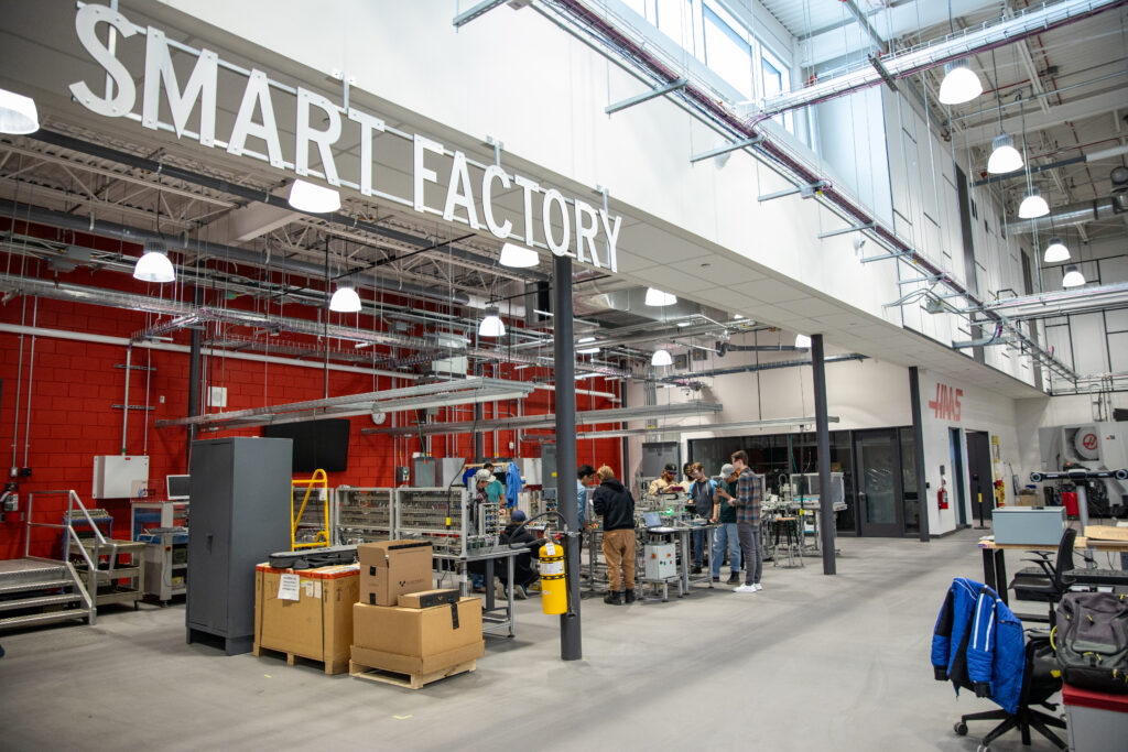 wide look at a group of students working in RRC Polytech's Smart Factory