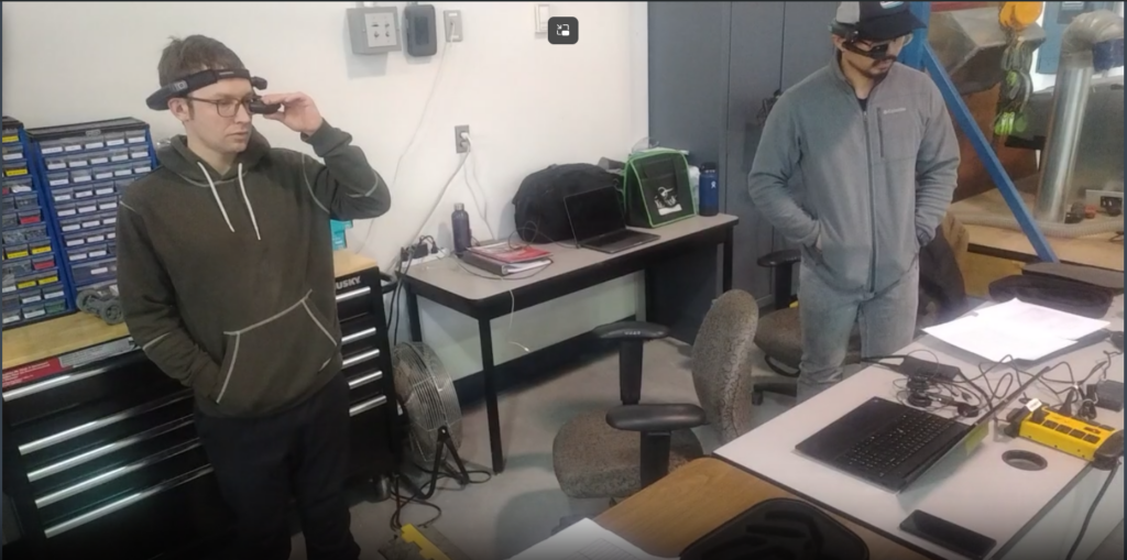 two researchers at VTEC wearing AR headsets