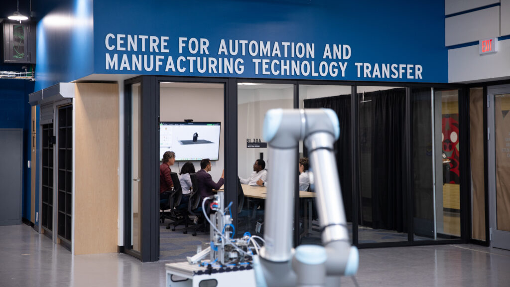 a robotic arm sits outside of the boardroom of RRC Polytech’s Centre for Automation and Manufacturing Technology Transfer (CAMTT).