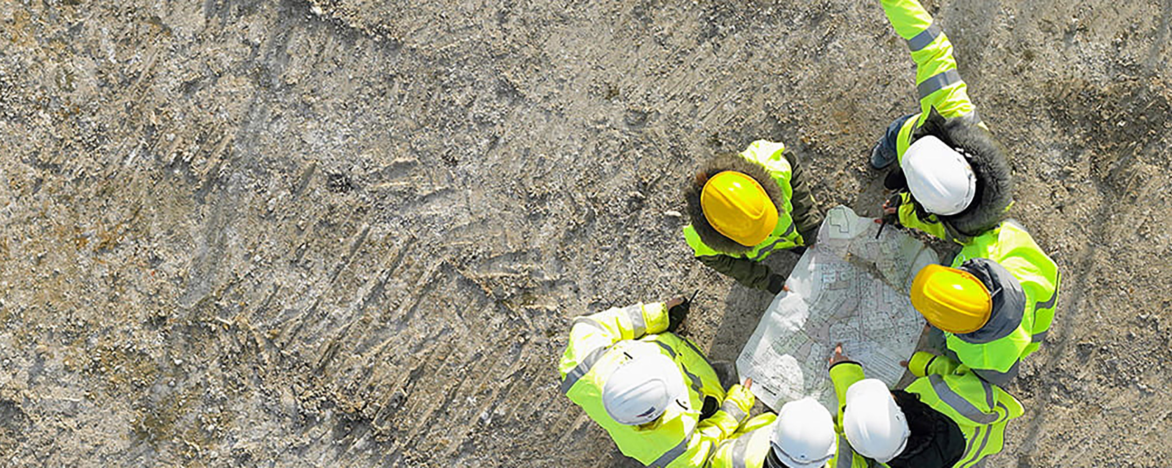 Group of people wearing hard hats at a construction site