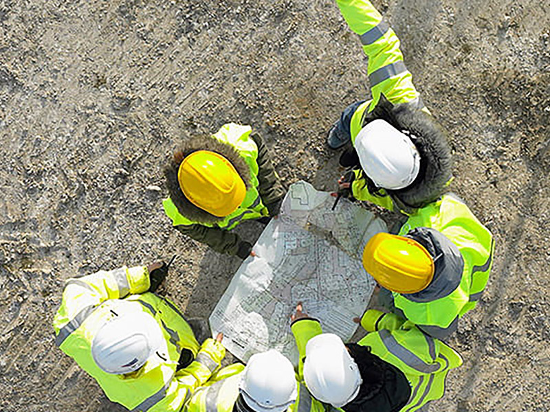 Group of people wearing hard hats at a construction site