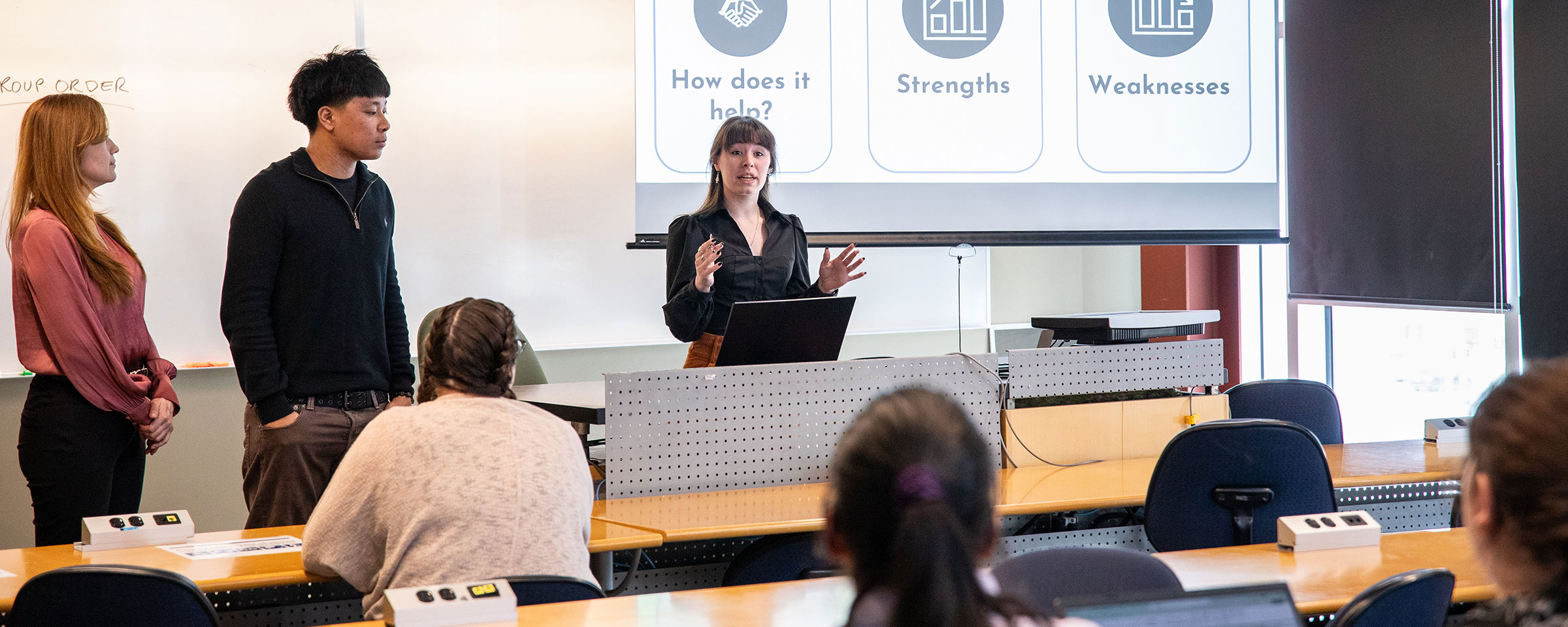 Instructor talking to a group of students in a classroom