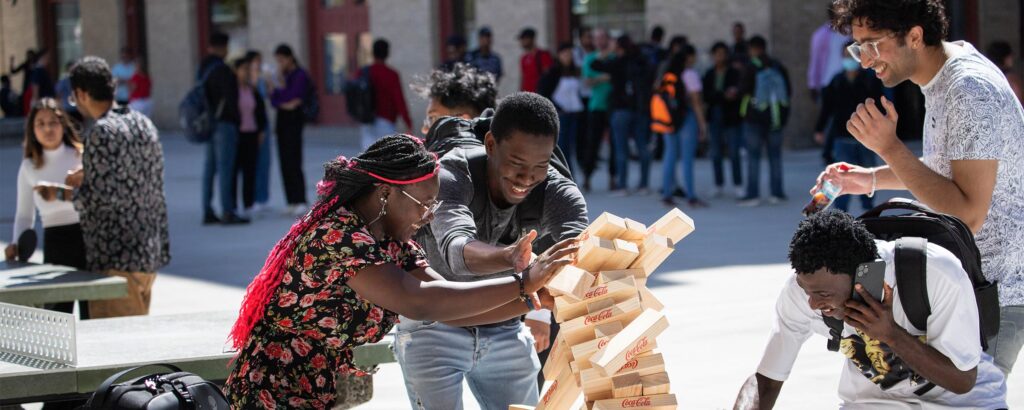 People outdoors playing Jenga