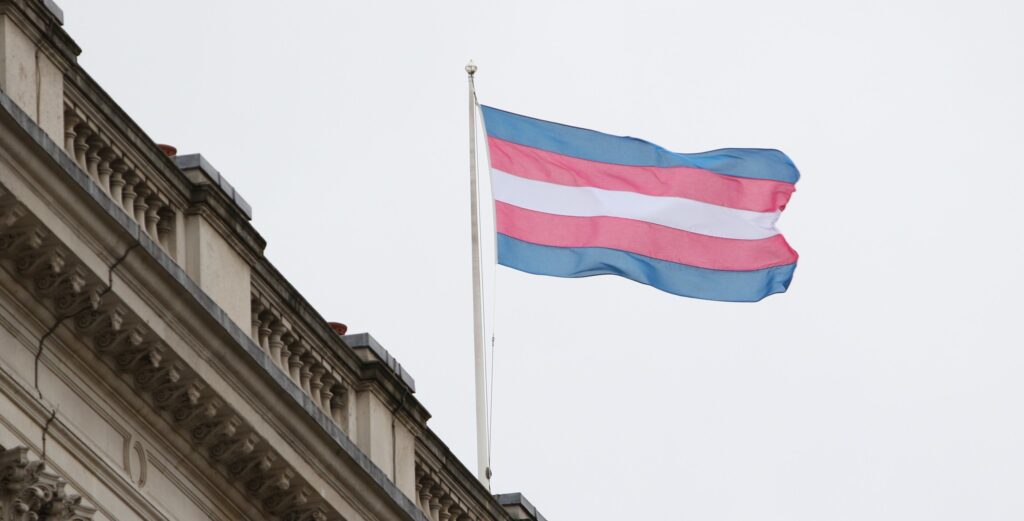Trans Flag flying on top of a building