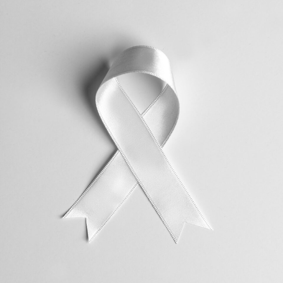 A white ribbon against a grey background.