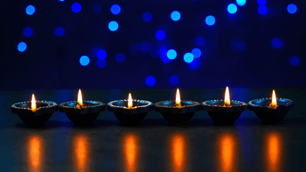 Six oil lamps are lit against a dark blue background.