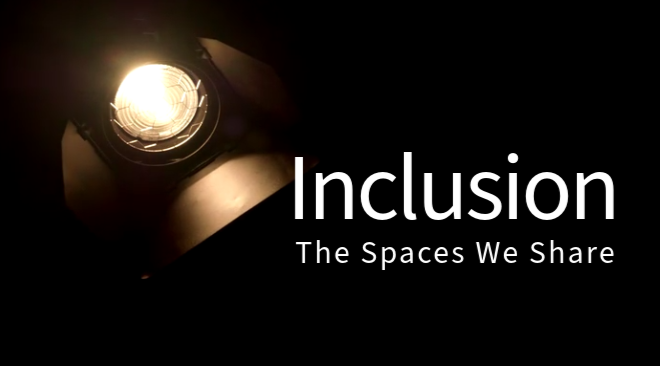 A stage light against a black background illuminates the words "Inclusion: The Spaces We Share"