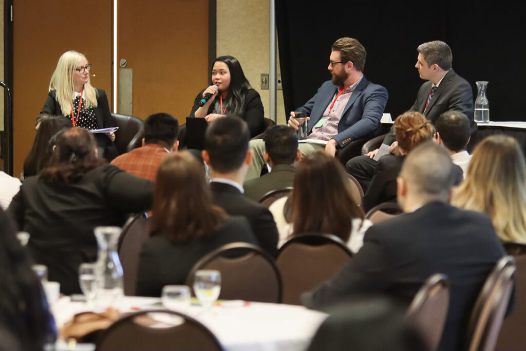 Students sitting around round tables at a conference