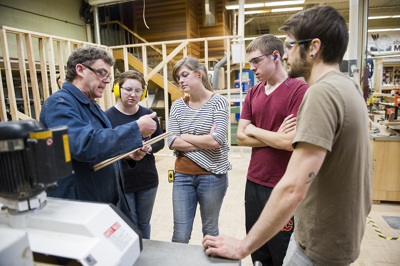 Teacher talking to students in wood shop