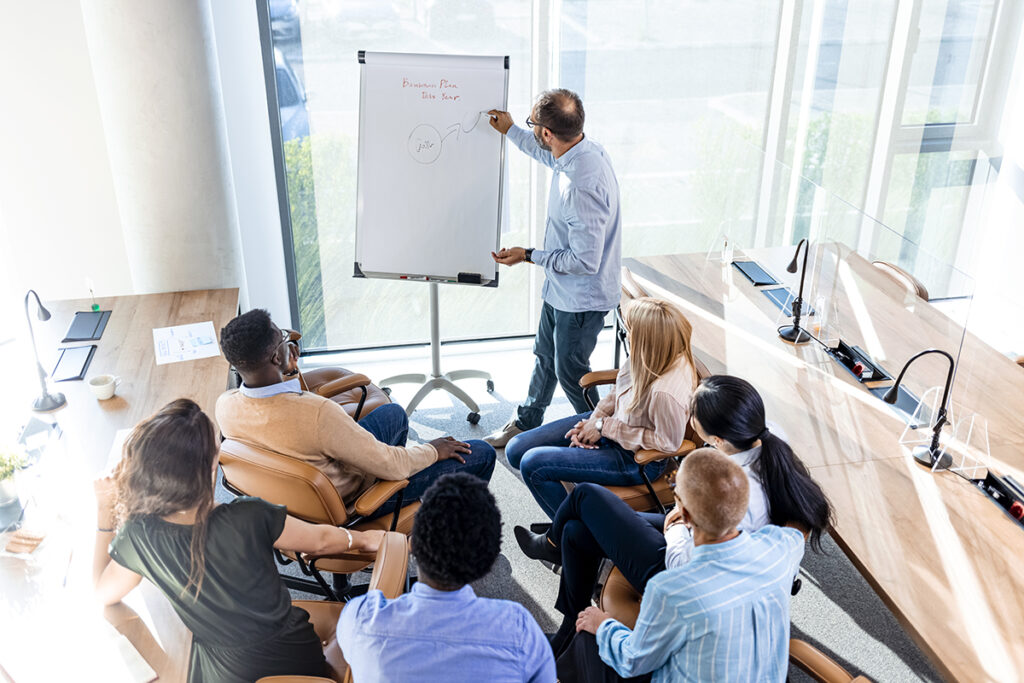 Person giving a presentation to colleagues in a meeting room