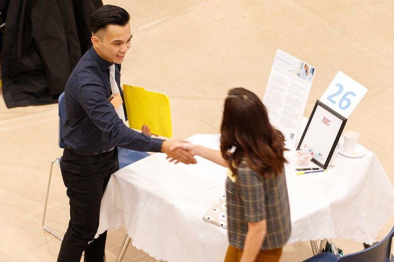 Two people shaking hands at conference