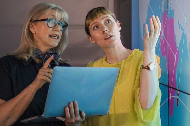 Two women looking at a presentation