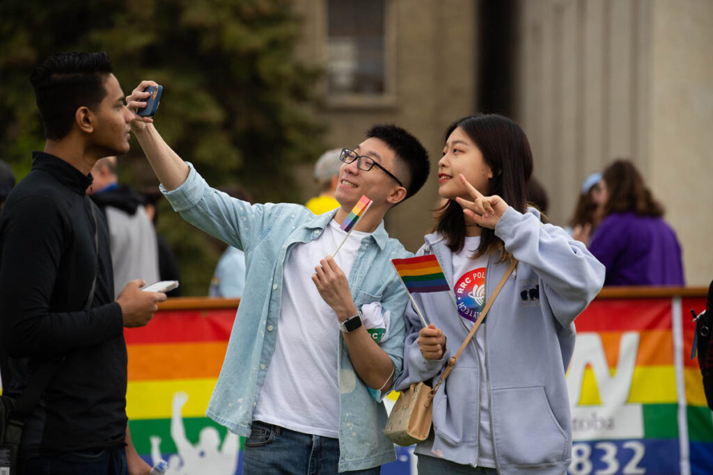 Students taking a selfie at a pride parade