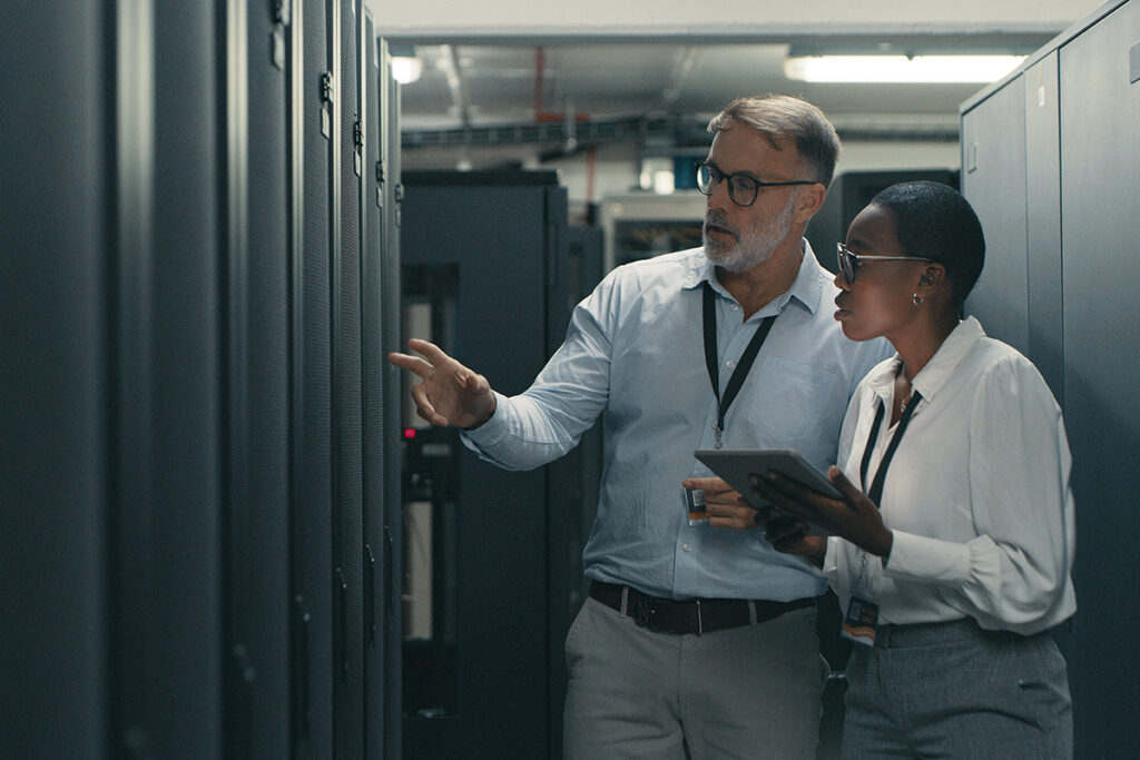 Two colleagues with a tablet looking at something in a networking room