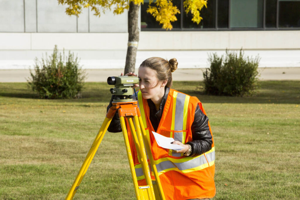 Civil engineering student using surveying equipment