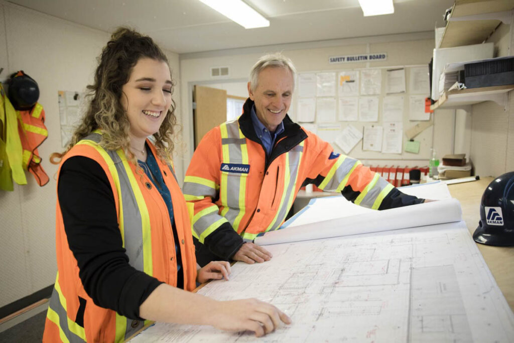 Instructor and student looking at architectural drawings