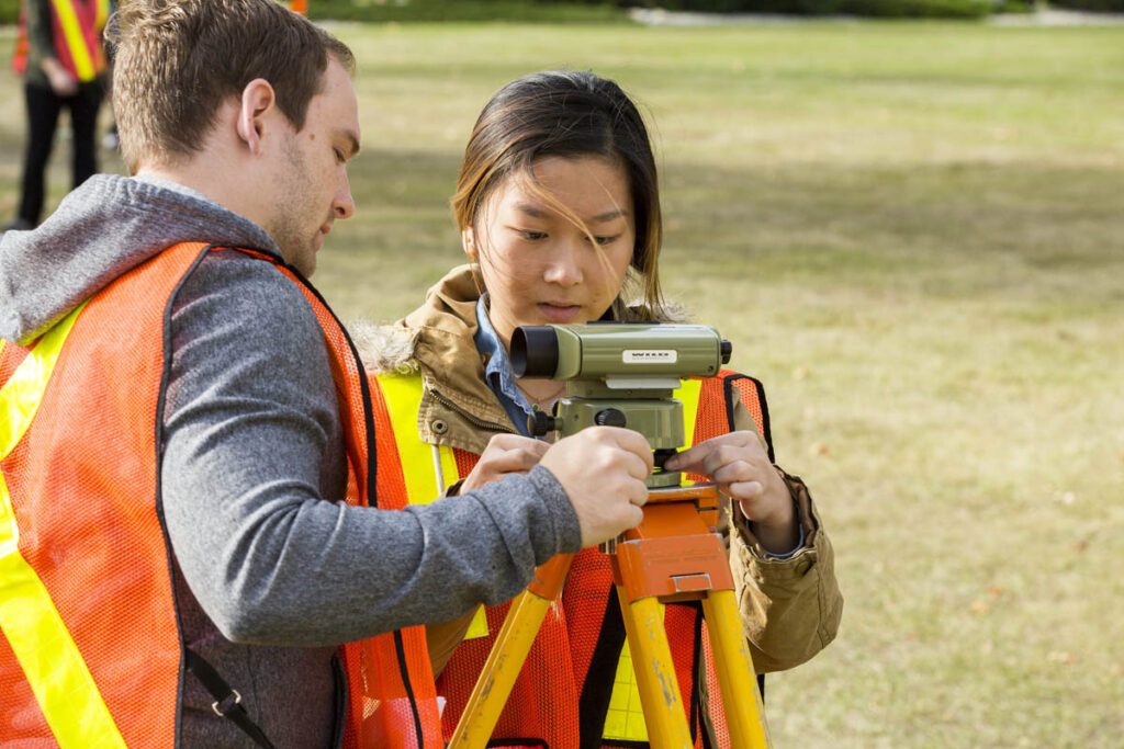 Civil engineering students learning how to use surveying tools