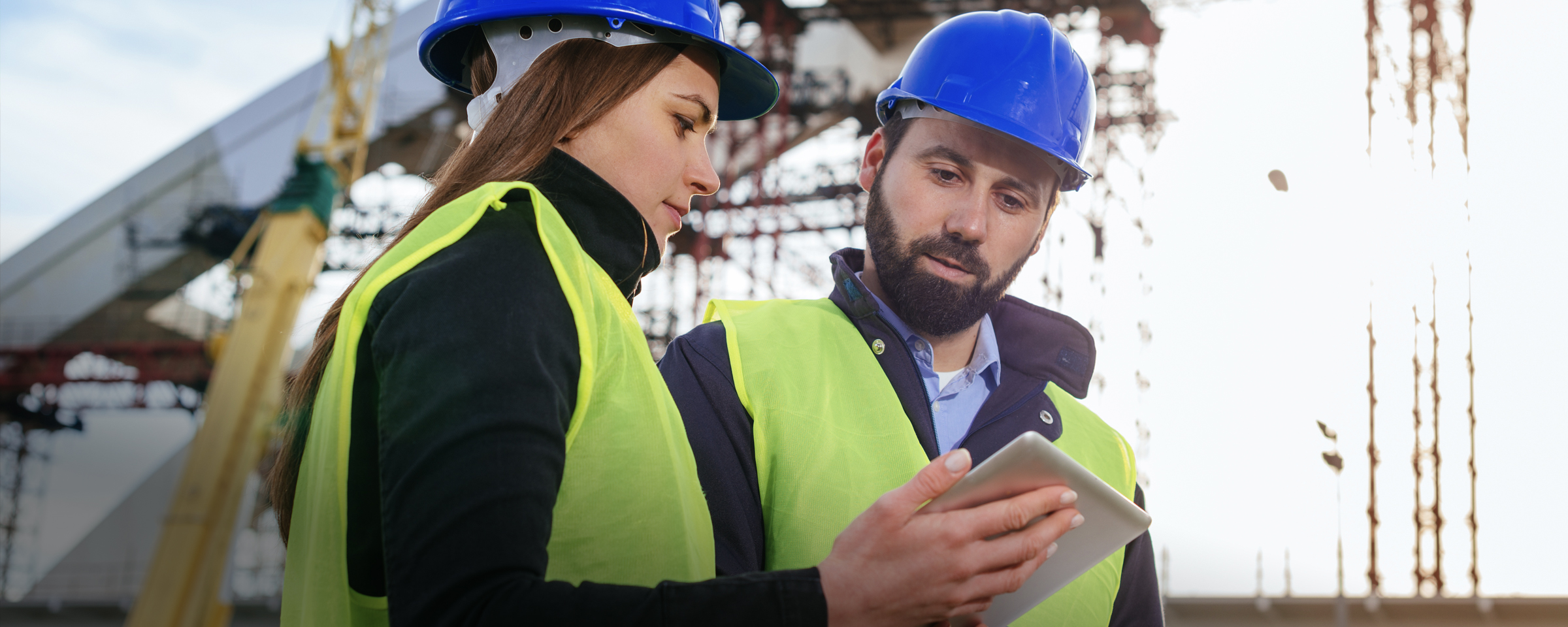 Two civil engineers talking to each other at a work site