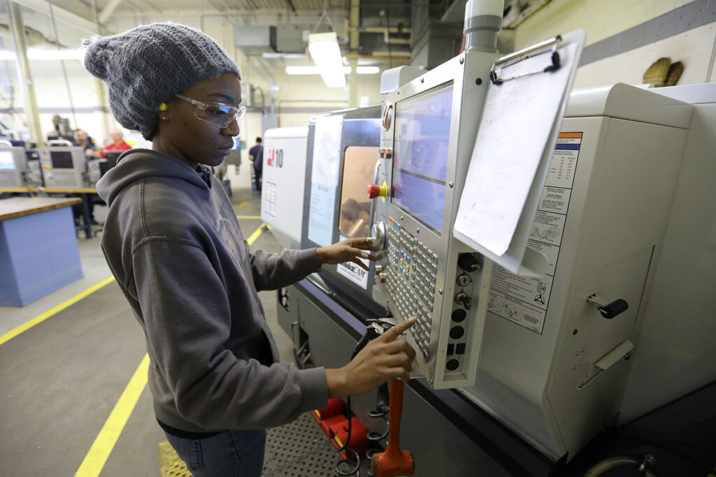 Student using a CNC machine in a lab