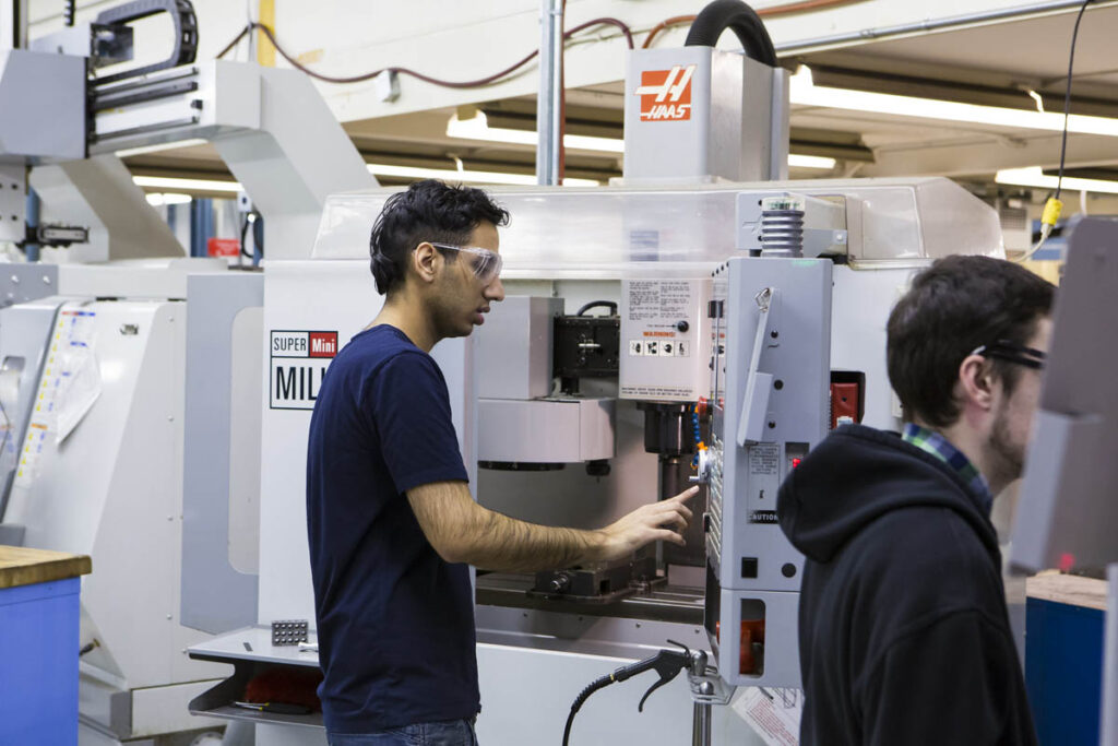 Student using a CNC machine in a lab