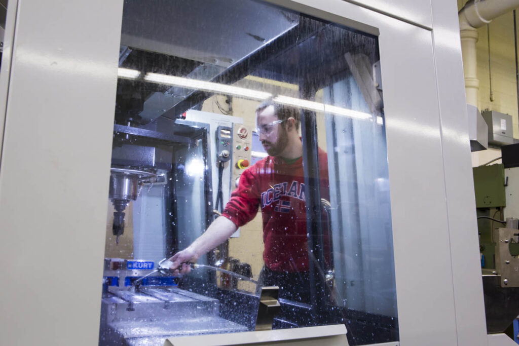 Student using a CNC machine in a lab