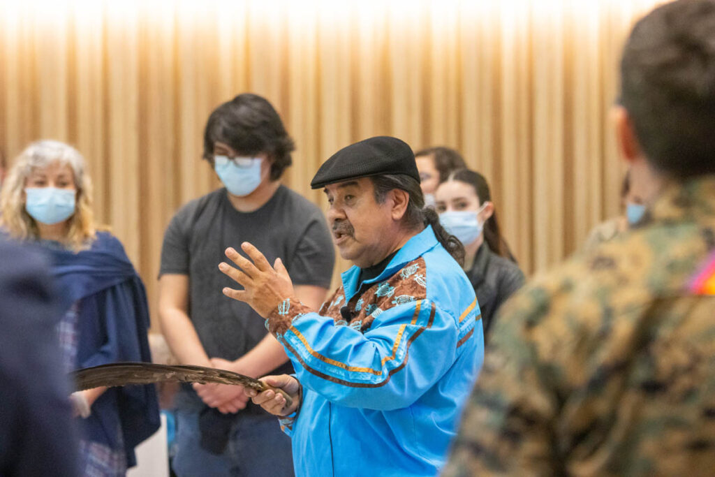 Group of people listening to an Elder speak