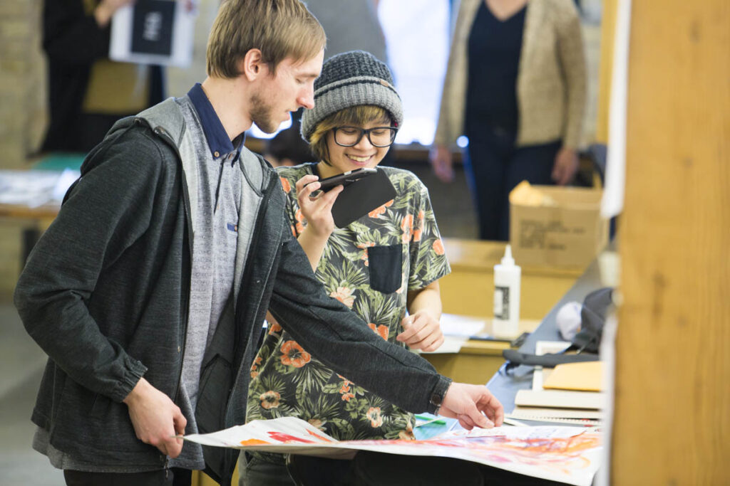 Design students taking photo of another designer's work