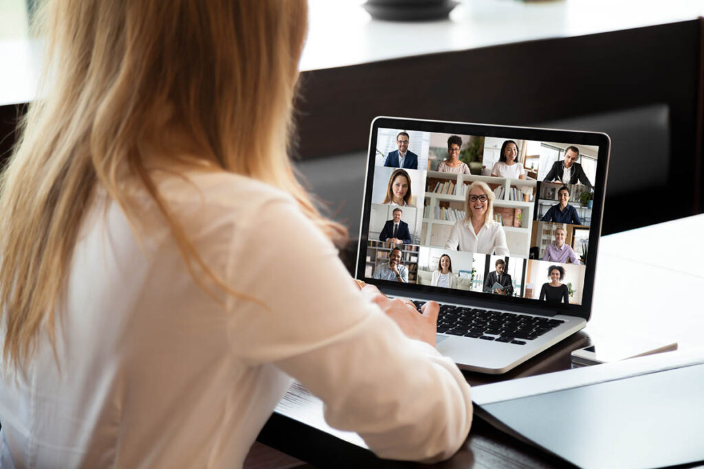 Woman video conferencing with colleagues on a laptop