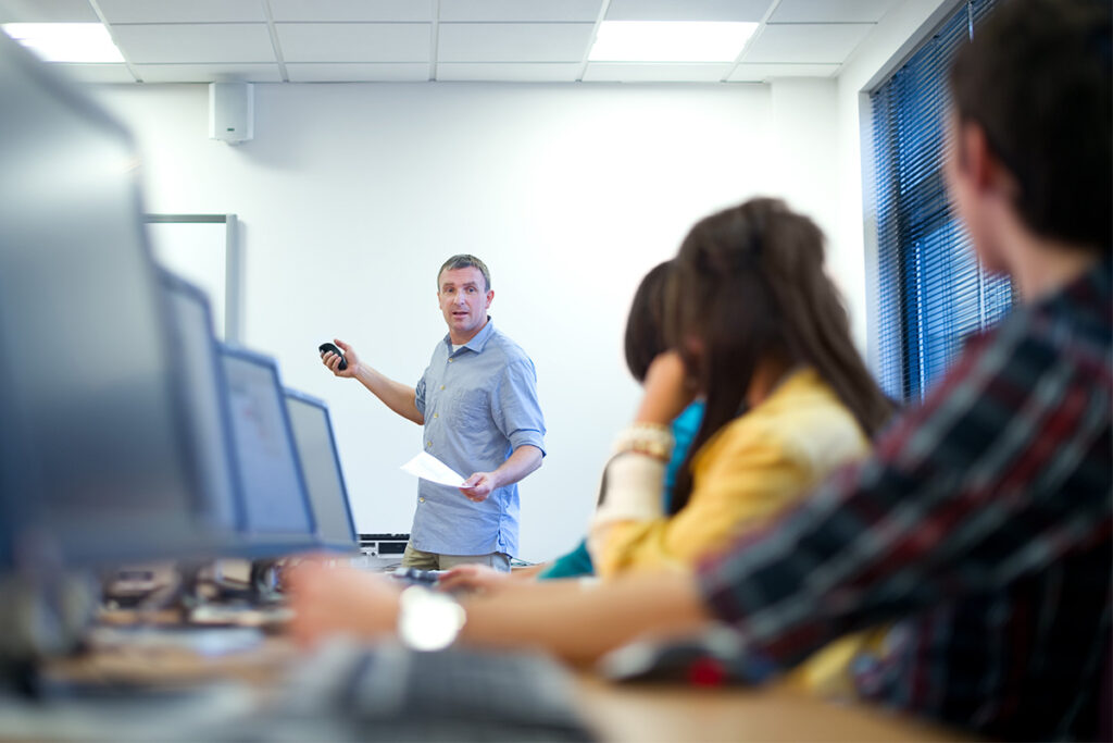 Instructor talking to class in a computer lab