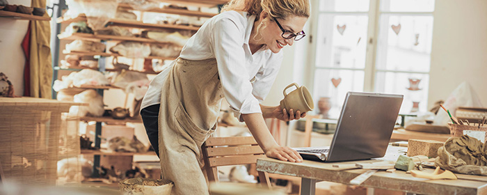 Woman in shop with laptop