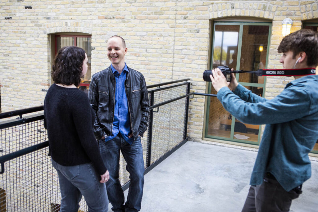 Person taking a photo of two students 