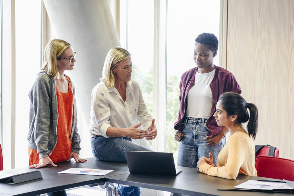 Four women collaborating on a project