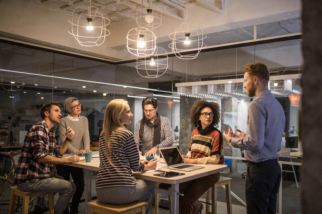 Man presenting to group in boardroom