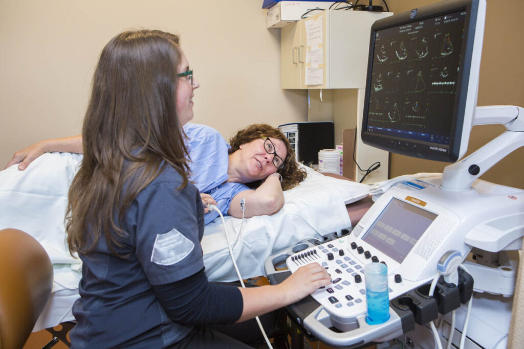 Sonography student doing imaging on patient