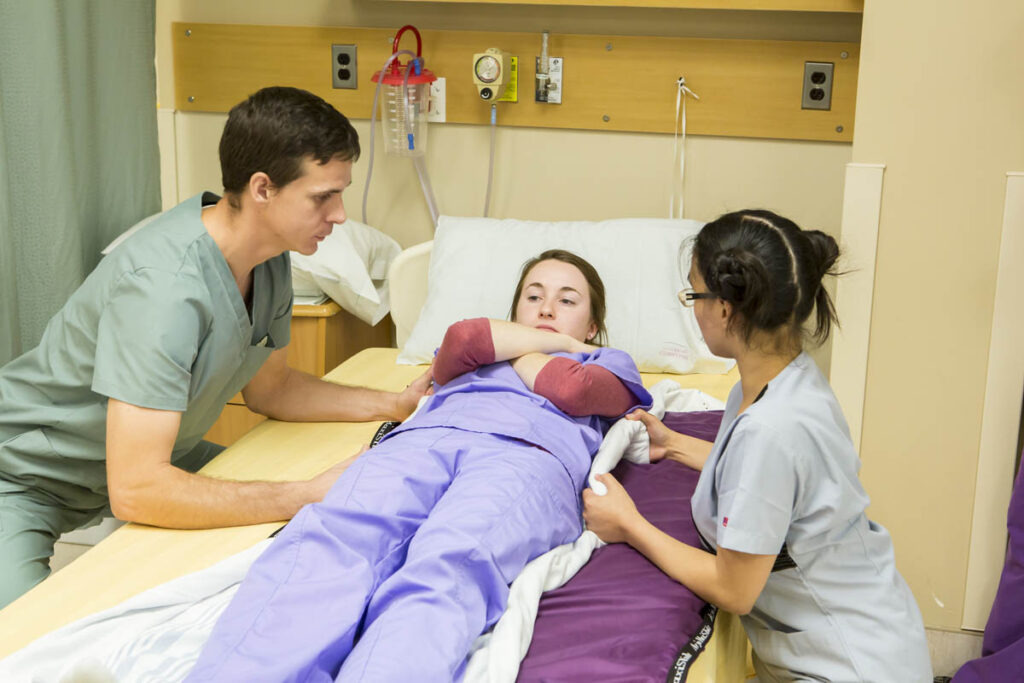Nurses helping to move patient