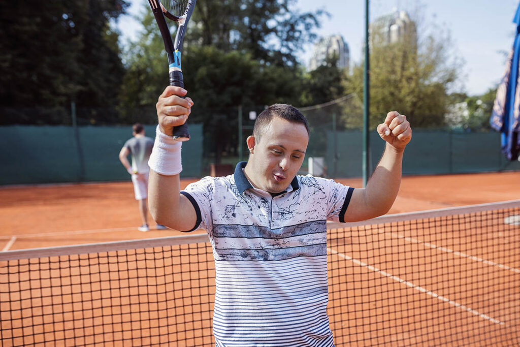 Person playing tennis on a clay court