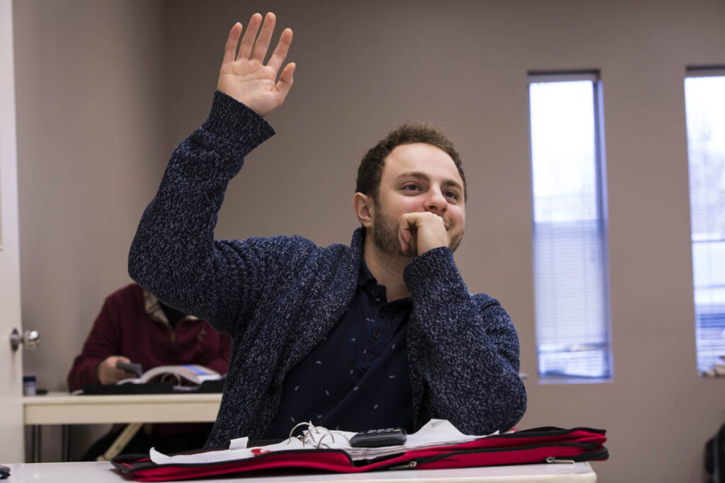 Man raising his hand in a classroom