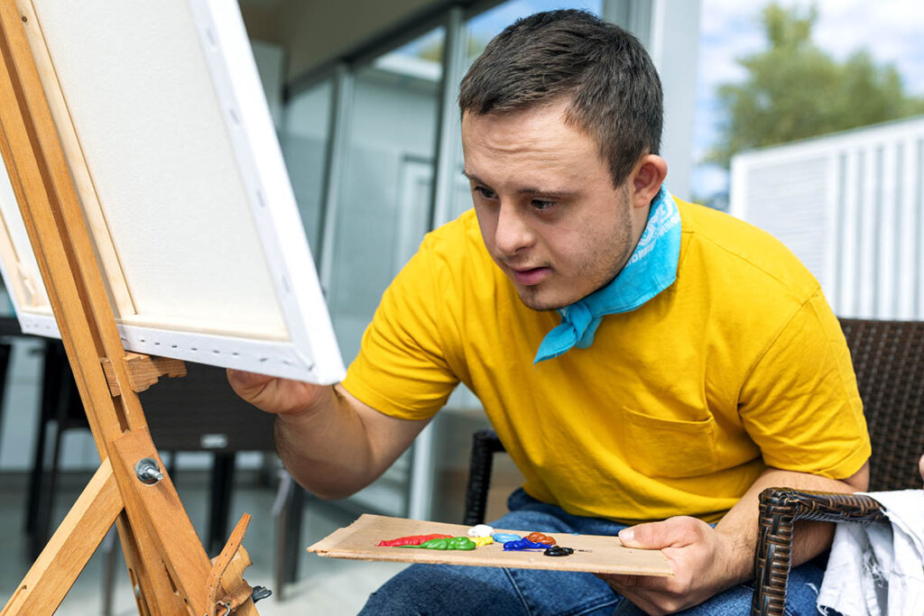 Person painting on canvas