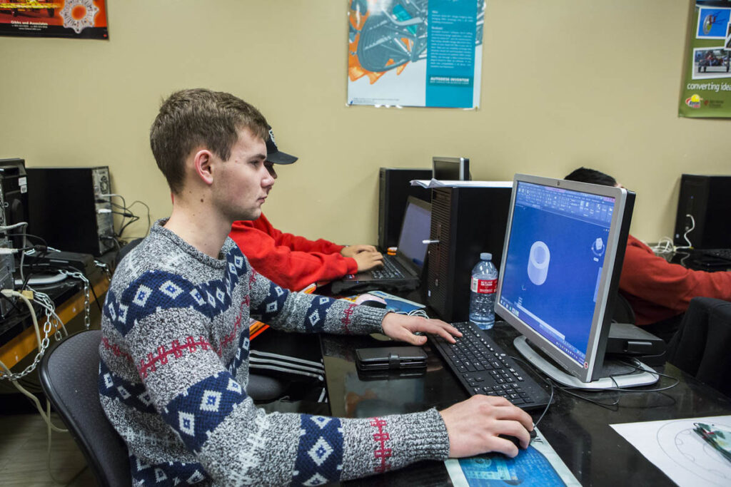 Man looking at CAD files on computer screen